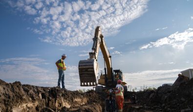 An excavator takes part in early site preparation work for the Darlington New Nuclear Project.