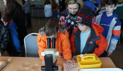 Children get a closer look with a microscope during the River Institute invertebrate workshop.