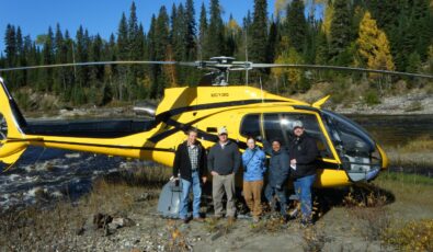 Gillian MacLeod, second from right, poses with colleagues in front of a helicopter after landing along the New Post Creek near OPG's Peter Sutherland Sr. hydro station.