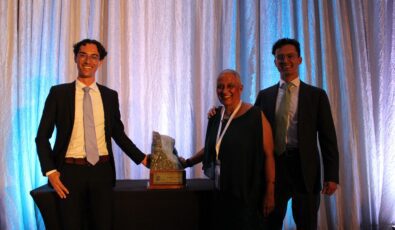 Gillian MacLeod stands with her sons as she receives the 2024 R.R. Dodokin Award from the Ontario Waterpower Association for her advancement of hydroelectric power in Ontario.