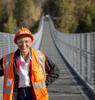 Gillian MacLeod, Senior Environment Specialist with OPG, poses on a suspension bridge near OPG's Ranney Falls Generating Station.