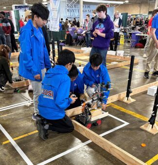 Students work on their robot during the robotics contest at the 2024 Skills Ontario Competition.