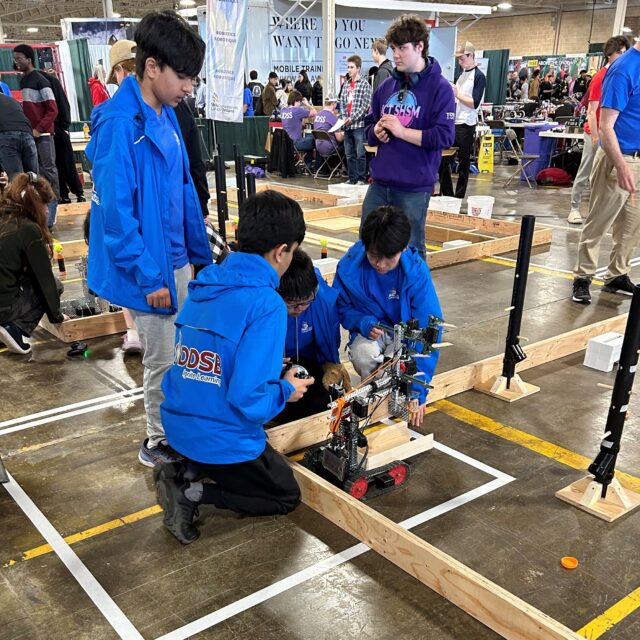Students work on their robot during the robotics contest at the 2024 Skills Ontario Competition.