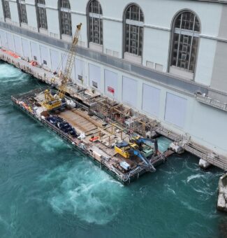 Using a sectional barge, workers dismantled the old tailrace deck at OPG's Sir Adam Beck I hydro station before constructing a new, wider deck and related upgrades.