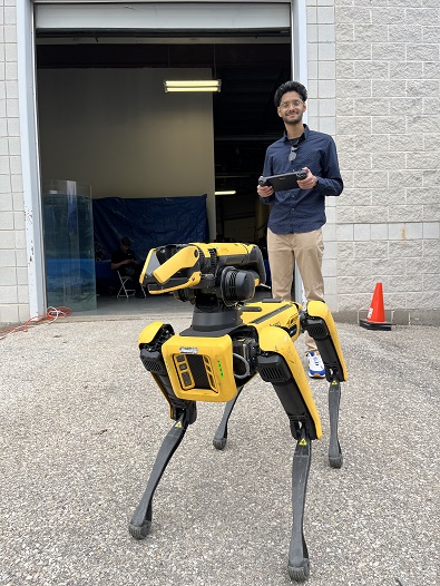 Dawson D'Silva controls a Boston Dynamics Spot robot dog.