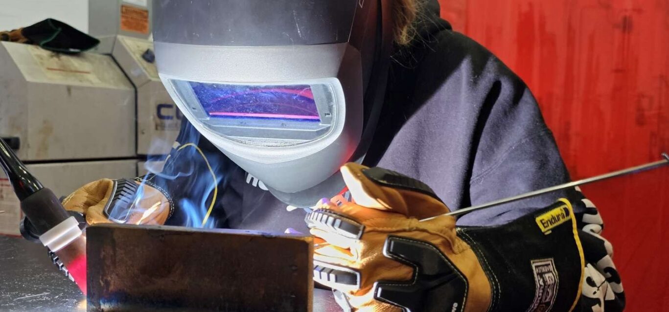 A woman takes part in trades activities.