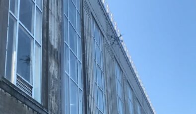 A drone cleans the powerhouse windows at OPG's Chats Falls hydro station in eastern Ontario.