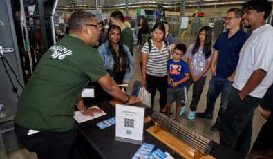 An OPG employee speaks with visitors during OPG's annual Community Power Expo on Sept. 14, 2024.