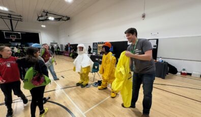 Students try on some protective gear for nuclear operations at a recent Trades Promoting Trades event in December.