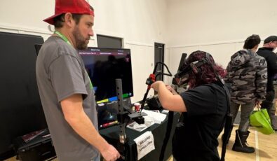 A student tries a welding simulator at a Trades Promoting Trades event.