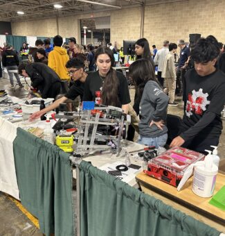 Students make some final adjustments to their robots at the 2025 Skills Ontario Competition.
