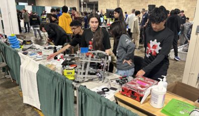 Students make some final adjustments to their robots at the 2025 Skills Ontario Competition.