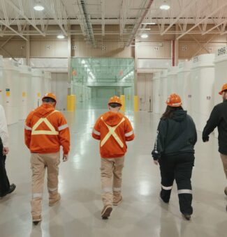 Nuclear Sustainability Services employees walking through waste facility.