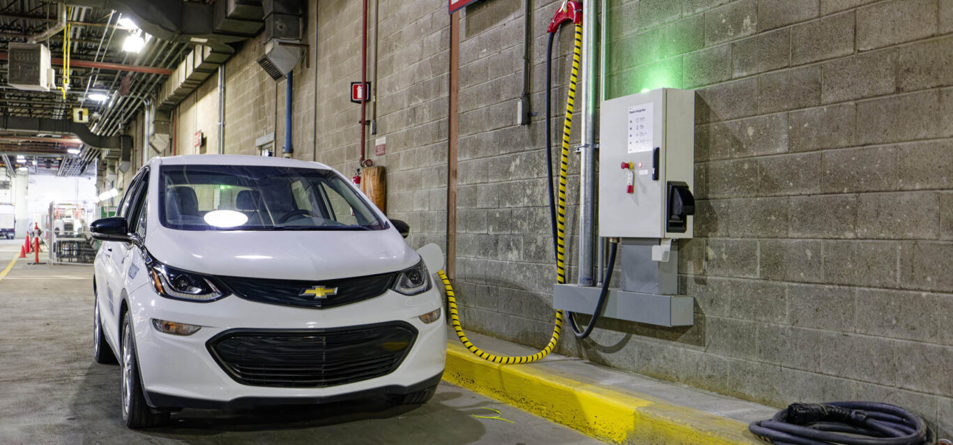 An electric vehicle at a charger.