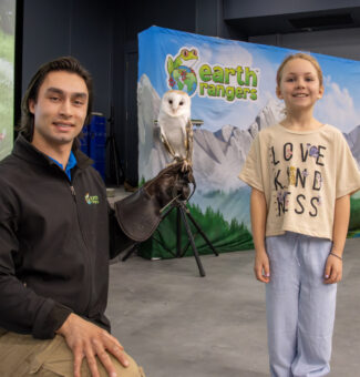 A child attends an OPG community event with partner Earth Rangers
