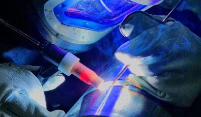 A mentee of Erik Dickerson shows off her welding skills.