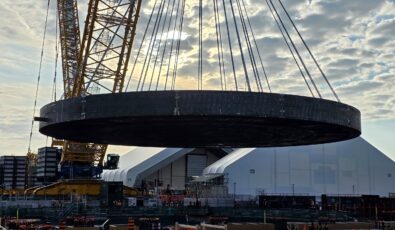 The massive Basemat component, which will serve as the foundation for the G7's first SMR, is lifted at the Darlington New Nuclear Project site.